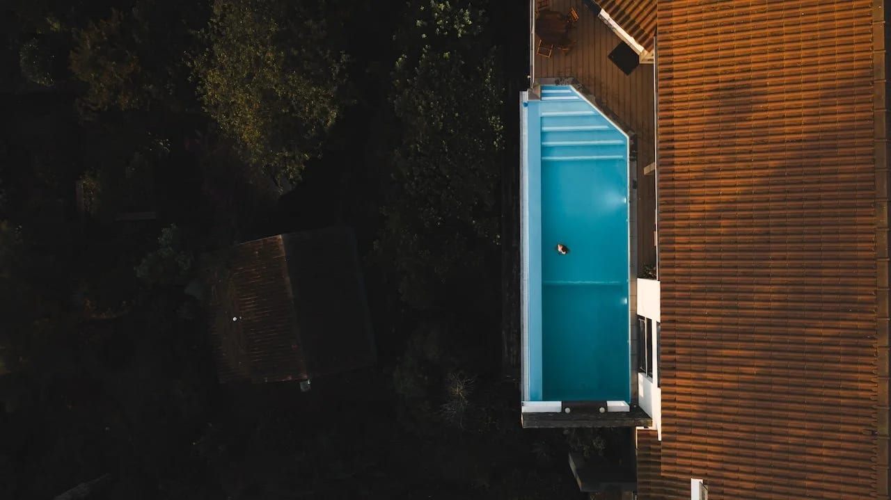 Aerial view of the villa with a guest swimming in the private pool